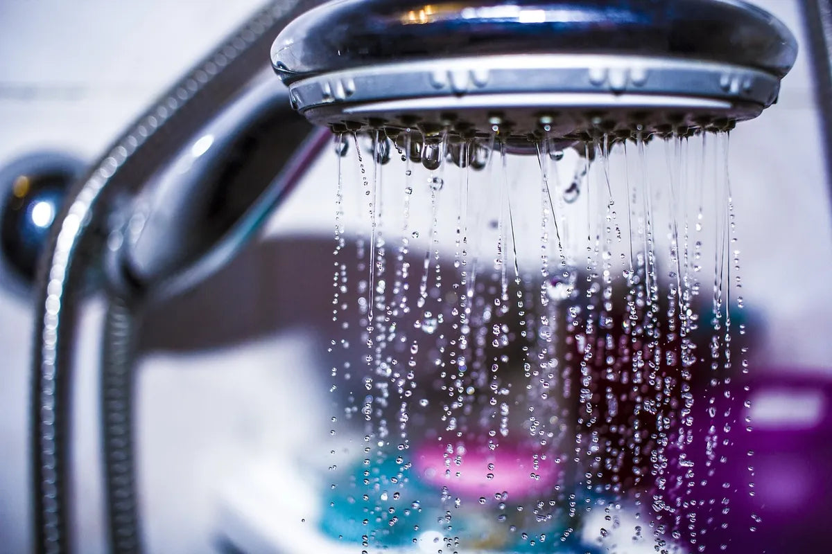 Eau qui jaillit d'un pommeau de douche en effet cascade